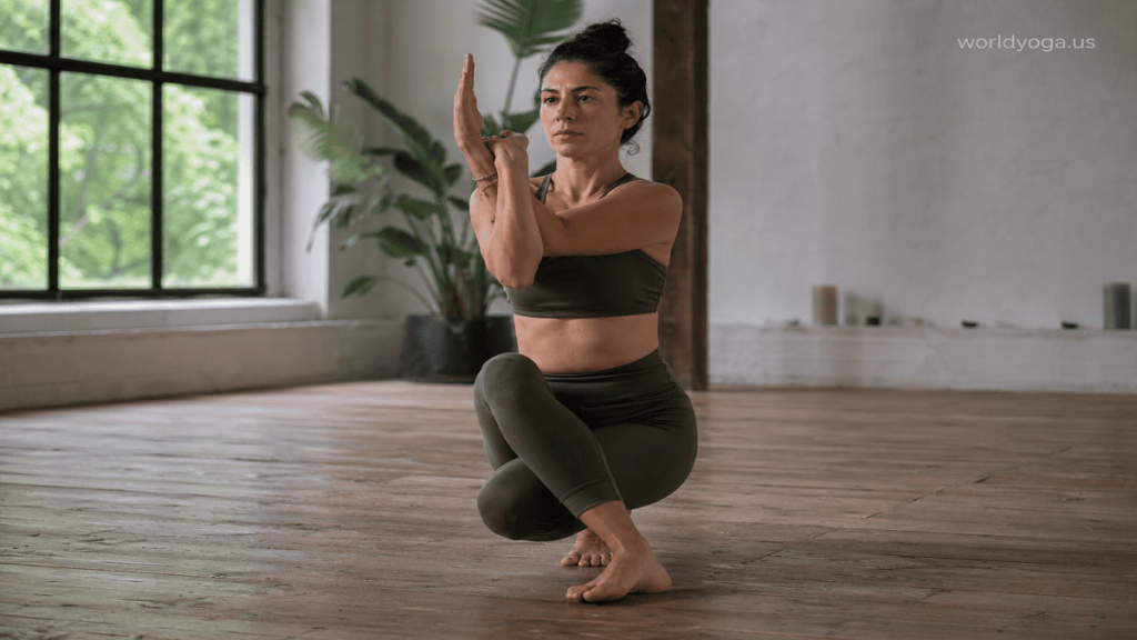 An advanced yogi performing Janu Garudasana in a kneeling position with crossed Garuda-style arms, demonstrating strong spinal alignment, hip stability, and controlled shoulder engagement.